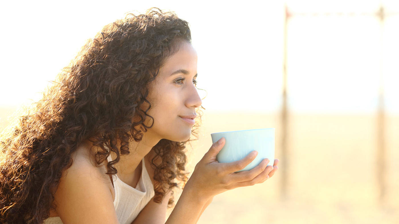 Virginia Beach Ketamine and Wellness | Woman drinking coffee in the sun